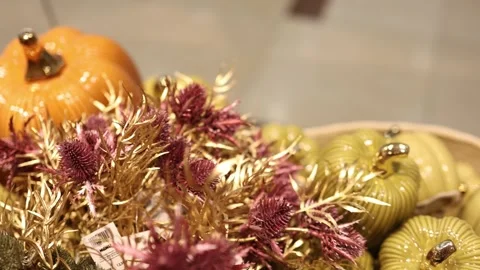 Green ceramic pumpkins and dried thistles create a natural autumn arrangement Stock Footage 347812953