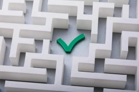 Green Check Mark Icon In The Centre Of Maze Stock Photos