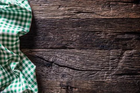Green checkered kitchen tablecloth on rustic wooden table Stock Photos