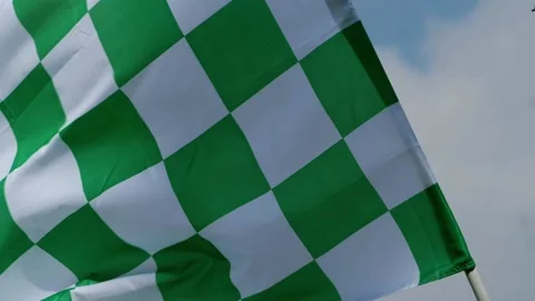 Green checkered racing flag blows in the wind Stock Footage 172546187