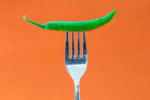 Green chilli in the fork Stock Photos