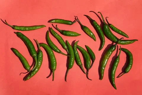 Green Chilli spice vegetables on red background 写真素材