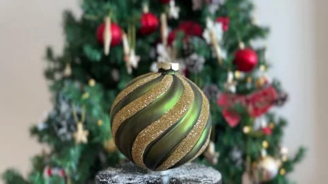 Green Christmas bauble rotating with blurred tree Stock Footage 341611588