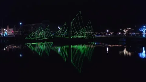 Green Christmas Lights in Sail Patterns Reflecting on Galway’s Water at Night Stock Footage 299724357