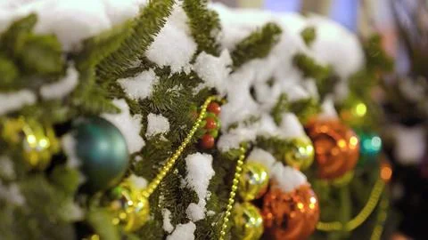 Green christmas tree decorated with snow and ball toys Stock Photos