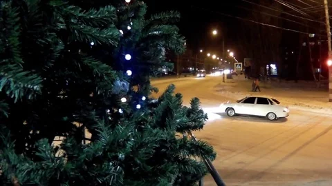 Green Christmas tree with lights standing in the road transport Stock Footage 70447043