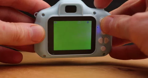 Green chromakey display in hands of tiny camera Stock Footage 156860137