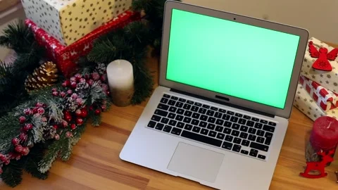 Green chromakey notebook with blank screen with New Year presents on background. 스톡 동영상 146317700