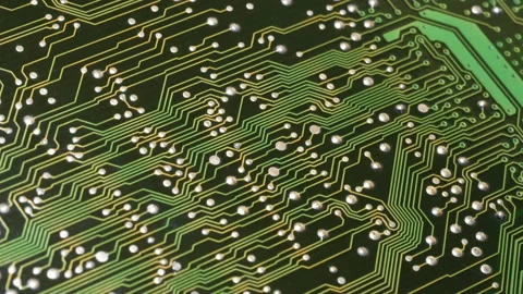 Green circuit board with conductive traces and electronic components Stock Footage