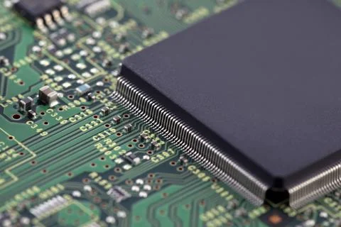 Green circuit board with large computer processor chip Stock Photos
