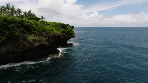 Green cliff edge above blue sea water. Siargao, Philippines. Stock Footage 321601712