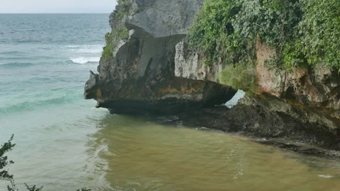 Green cliffs and Indian ocean waves on Blue Point Suluban Beach, Bali - 4K Stock Footage 183310488
