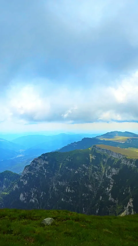 Green cliffs and plateau under dramatic sky. Vertical video. Stock Footage 321888881