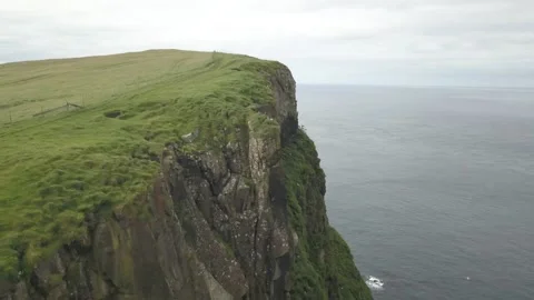 Green cliffs of farroe islands in cloudy weather Stock Footage 141160742