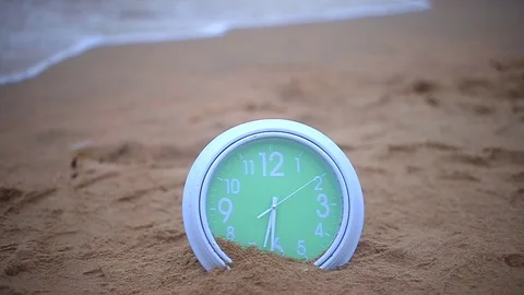 Green clock on the beach Stock Footage 94018083