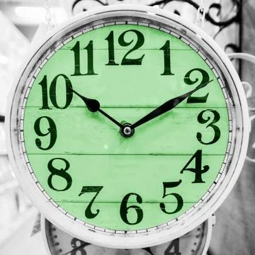 Green clock in a classical style. Stock Photos