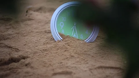 Green clock on sandy Stock Footage 94018073