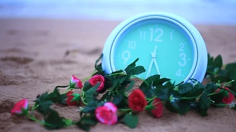 Green clock spining on the the brown sandy Stock Footage 94018419