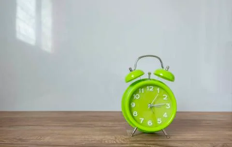 Green clock with white background Stock Photos