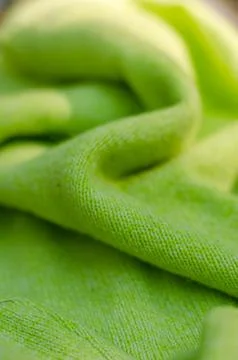 Green cloth waves background texture. Green fabric cloth textile material. Stock Photos