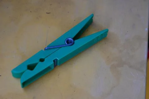 Green clothespin on a tabletop Stock Photos