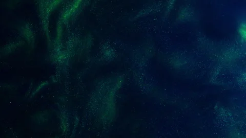 Green cloud of paint waving underwater. Shiny ink drops swirling in water Video stock 246769559