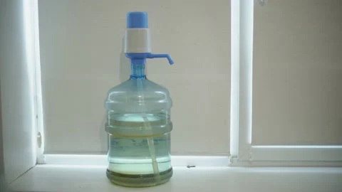 Green coating on the bottom of a large, 19 liter bottle for drinking water. Stock Footage 239611242