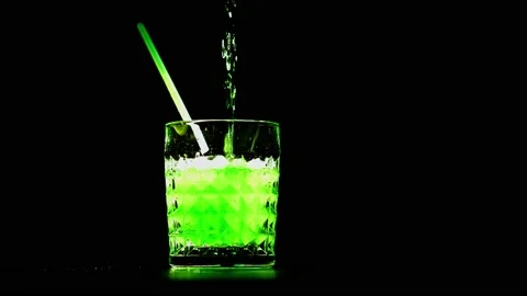 Green cocktail bubbles in goblet with straw. Video stock 169377547