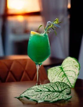 Green cocktail with ice on the table Stock Photos