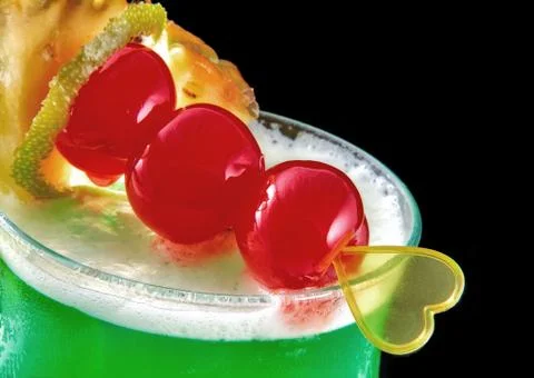 Green cocktail with yellow heart, valentine's day, cherry, iso Stock Photos