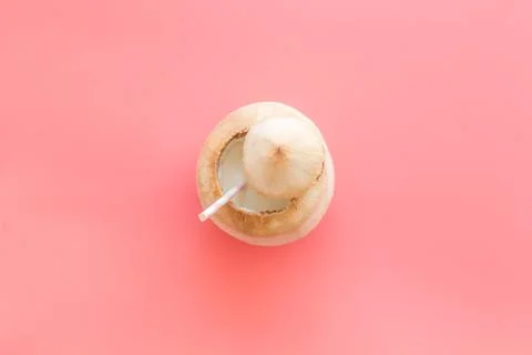 Green coconuts with drinking straw - tropical cocktail, above view Stock Photos