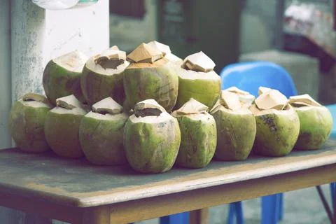 Green coconuts on table Stock Photos