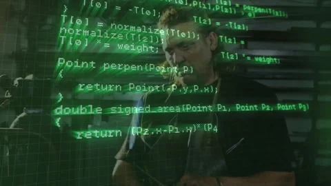 Green code overlay appearing on man standing in workshop while software Stock Footage 313703501