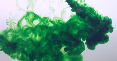 Green color paint ink drops in water at white background. Inky cloud flowing Stock Footage 122945129