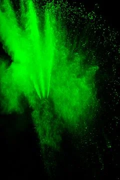 Green color powder explosion cloud on black background.Green dust splash on.. イラスト素材