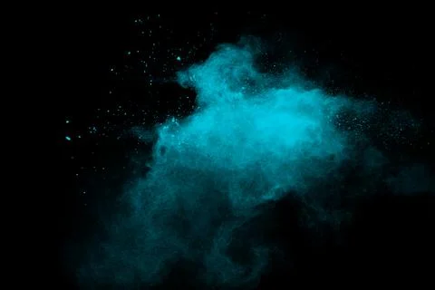 Green color powder explosion cloud on black background.Green dust splash. Stock Photos