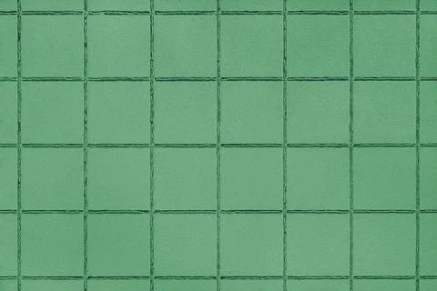 Green colored ceramic tile texture, background with square geometric patter.. 写真素材