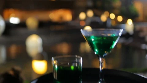 Green colored cocktail on defocused background Stock Footage 120406792