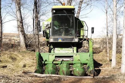 A green colored corn harvester machine Stock Photos