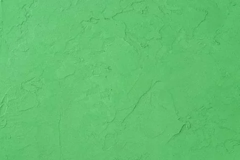 Green colored decorative plaster surface. Light green concrete background. Stock Photos