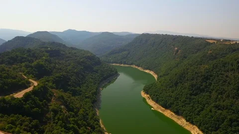 Green colourful river between mountain and small church on the hill Stock Footage 119398067