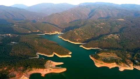 Green colourful river between mountain and small church on the hill Stock Footage 119398094