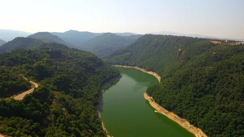 Green colourful river between mountain and small church on the hill Stock Footage 119398129