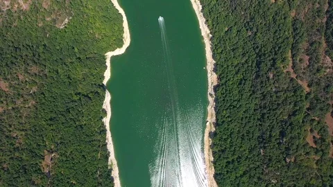 Green colourful river between mountain and small church on the hill Stock Footage 119398156