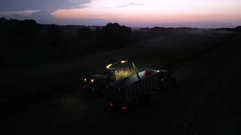 Green combine chopping corn silage in Ukraine at night 스톡 동영상 298043090