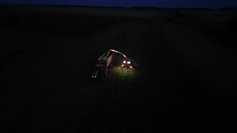 Green combine chopping corn silage in Ukraine at night 스톡 동영상 298051592
