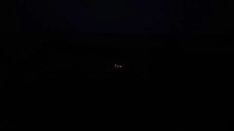 Green combine chopping corn silage in Ukraine at night Stock Footage 298068204