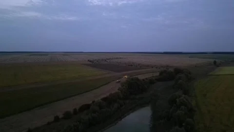 Green combine chopping corn silage in Ukraine at night Stock Footage 298068268