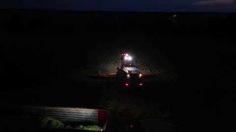 Green combine chopping corn silage in Ukraine at night Stock-Footage 298068468