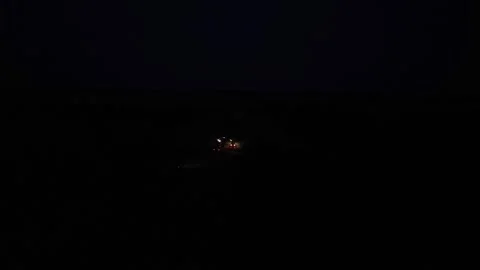 Green combine chopping corn silage in Ukraine at night Stock Footage 298070101